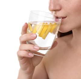 Woman drinking water with lemon on white background, closeup