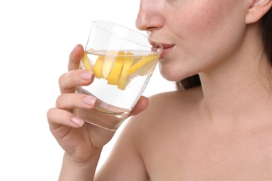 Photo of Woman drinking water with lemon on white background, closeup