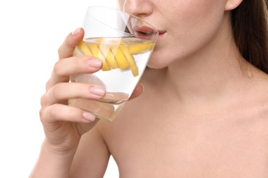 Photo of Woman drinking water with lemon on white background, closeup