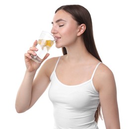 Woman drinking water with lemon on white background