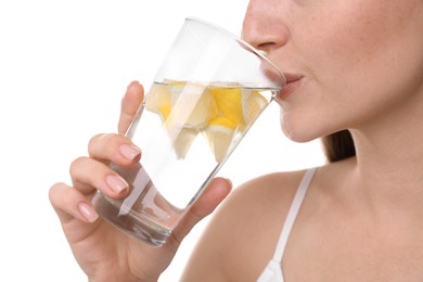 Woman drinking water with lemon on white background, closeup