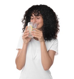 Woman drinking water with lemon on white background