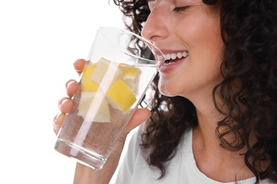 Woman drinking water with lemon on white background, closeup