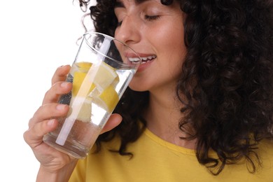 Photo of Woman drinking water with lemon on white background, closeup