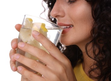 Woman drinking water with lemon on white background, closeup