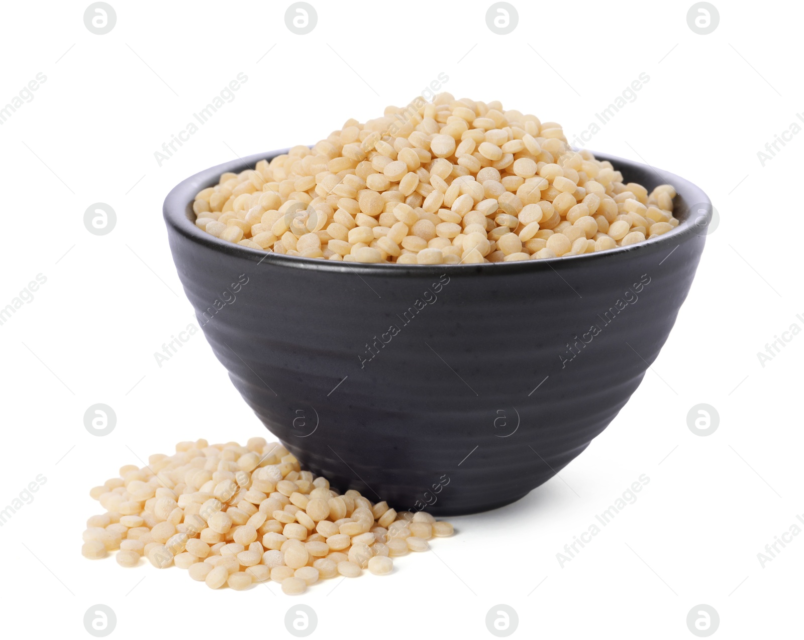 Photo of Raw couscous in bowl isolated on white