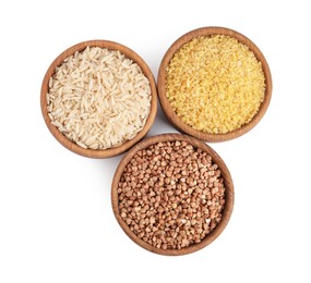 Photo of Different cereal grains in wooden bowls isolated on white, top view