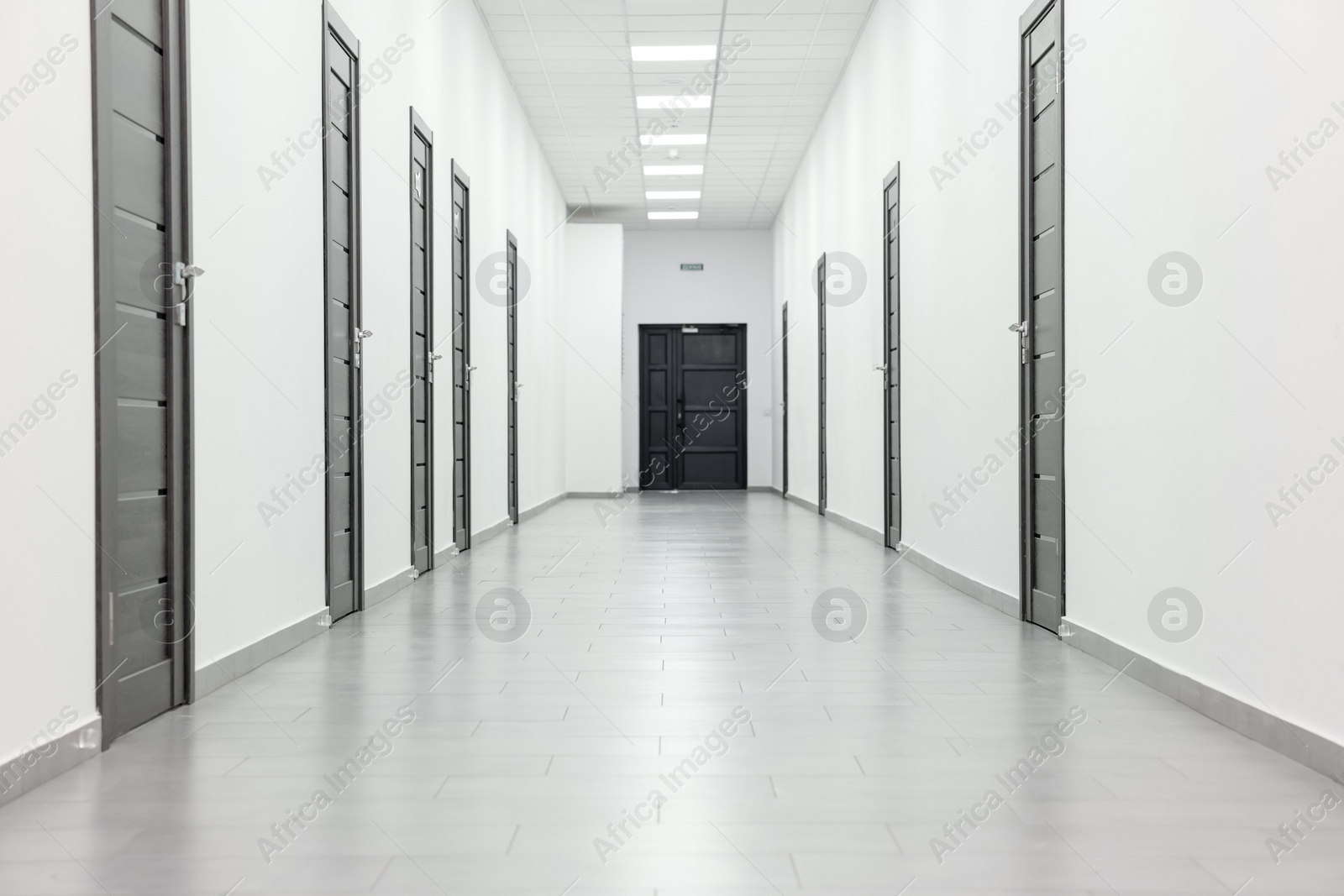 Photo of View of empty hospital corridor with wooden doors