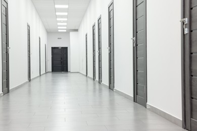 Photo of View of empty hospital corridor with wooden doors