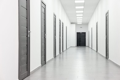 Photo of View of empty hospital corridor with wooden doors