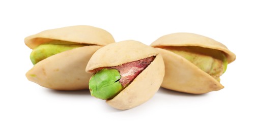 Three tasty pistachio nuts isolated on white