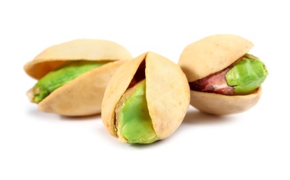 Photo of Three tasty pistachio nuts isolated on white