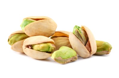 Photo of Heap of tasty pistachio nuts isolated on white