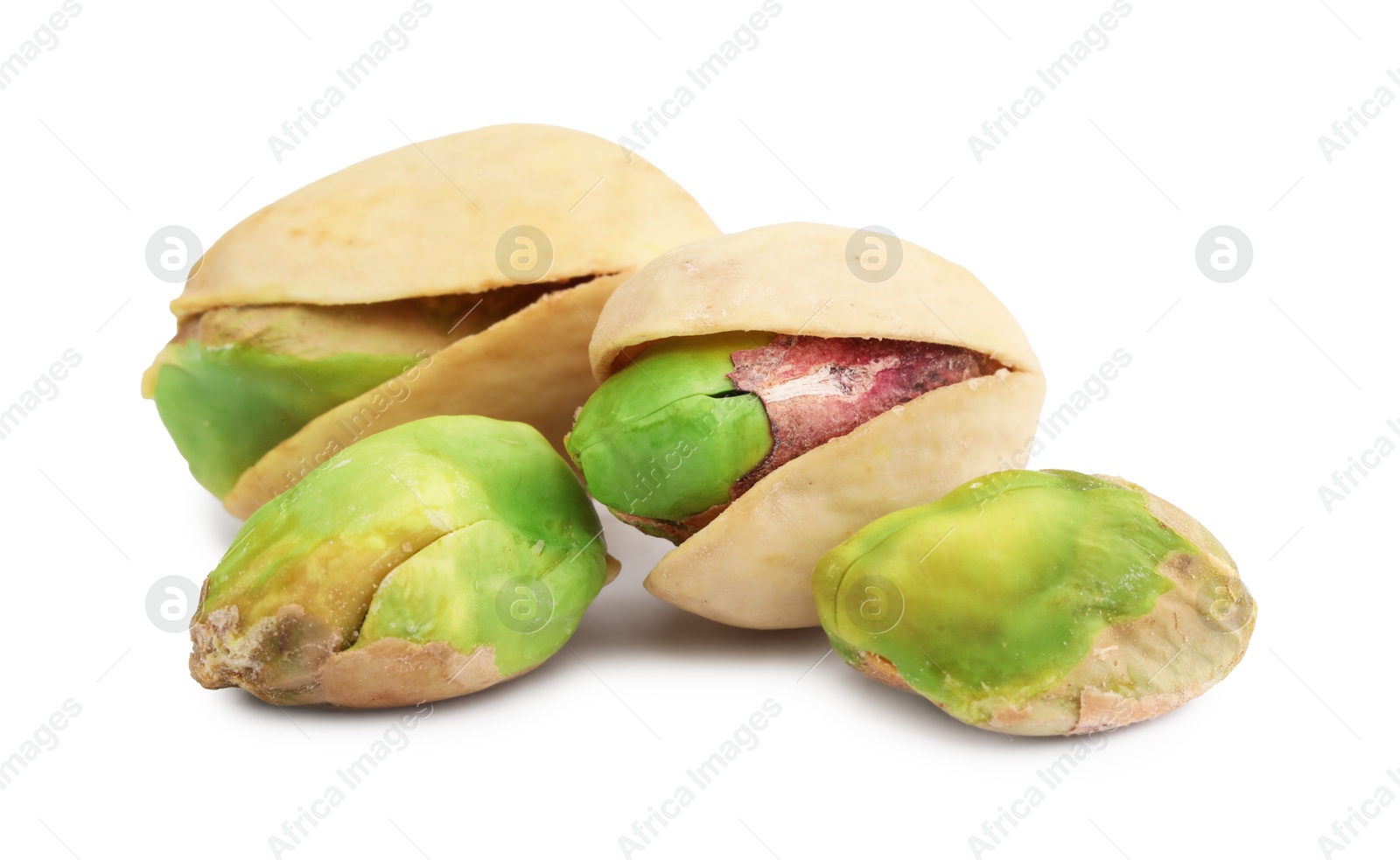 Photo of Many tasty pistachio nuts isolated on white