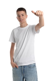 Teenage boy wearing t-shirt and showing thumbs up on white background