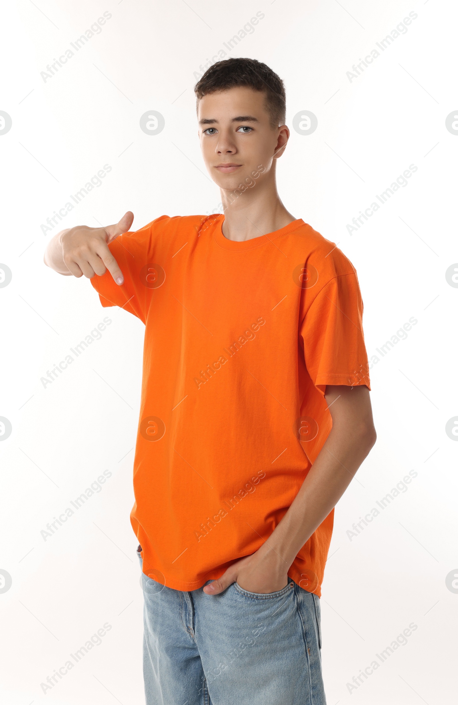 Photo of Teenage boy wearing orange t-shirt on white background