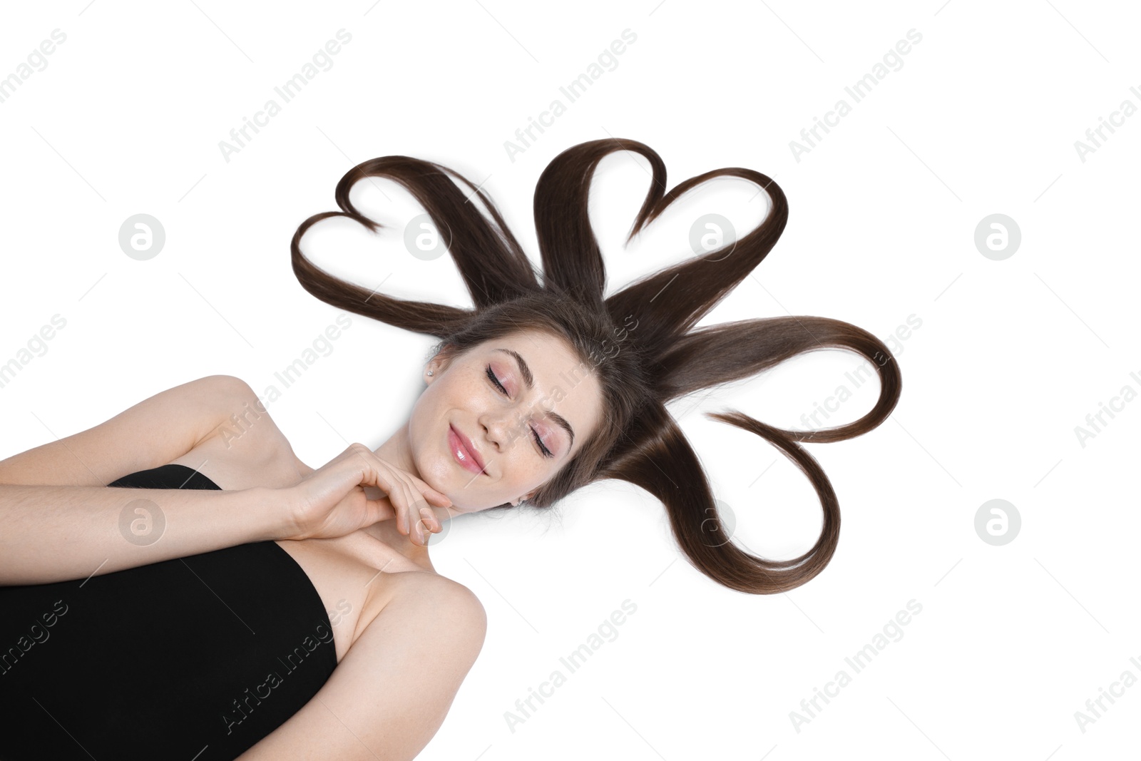 Photo of Beautiful young woman with hair in shape of hearts on white background