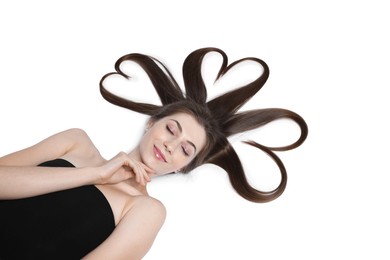 Photo of Beautiful young woman with hair in shape of hearts on white background