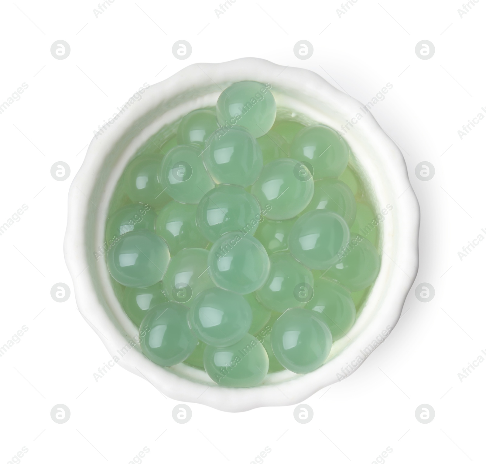 Photo of Bright tapioca pearls in bowl isolated on white, top view