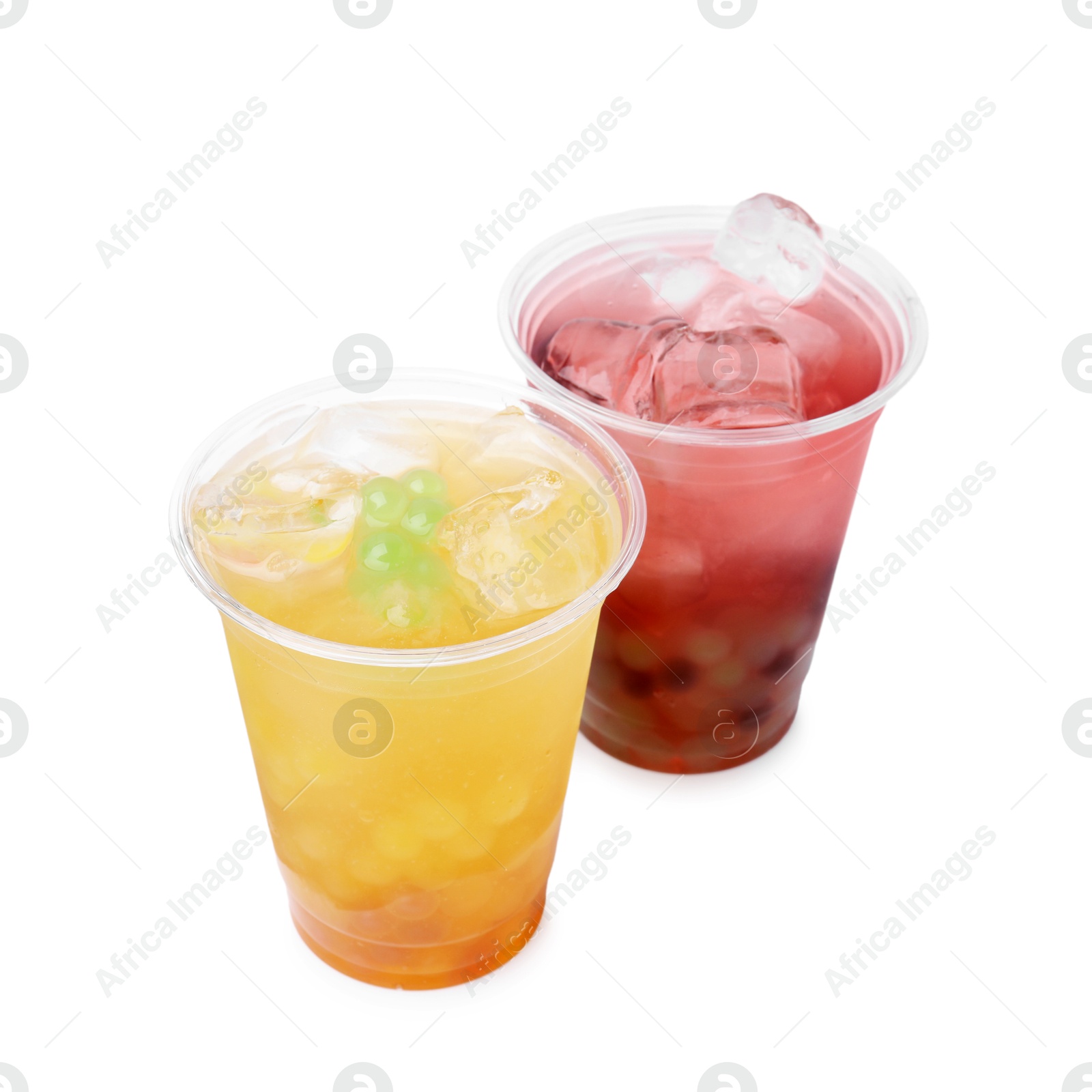 Photo of Tasty bubble tea in plastic cups isolated on white