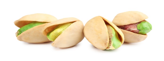 Many tasty pistachio nuts isolated on white