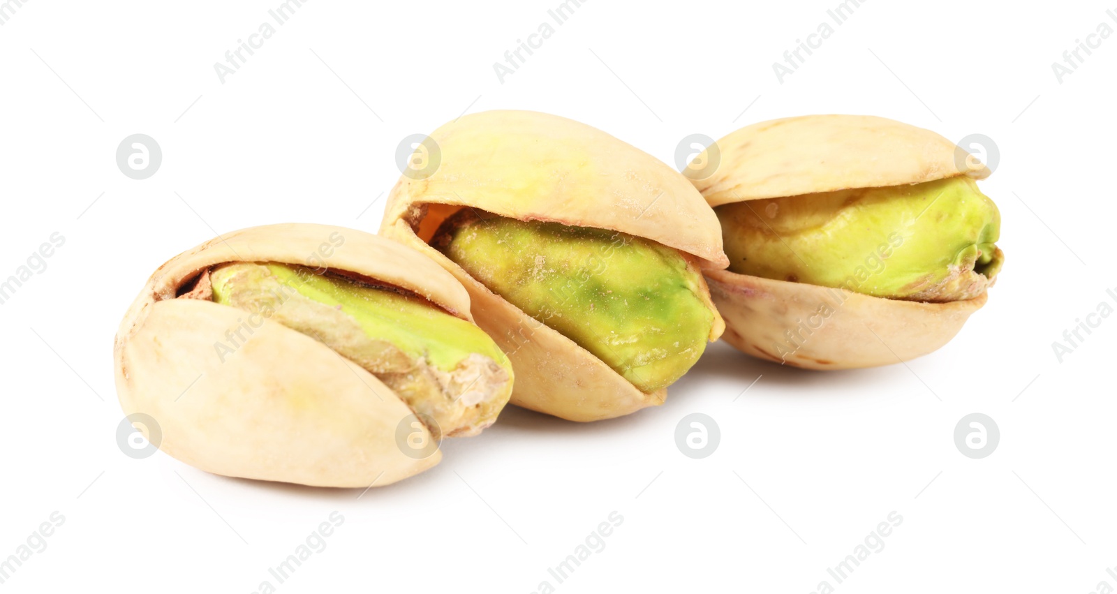 Photo of Three tasty pistachio nuts isolated on white