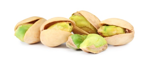 Many tasty pistachio nuts isolated on white