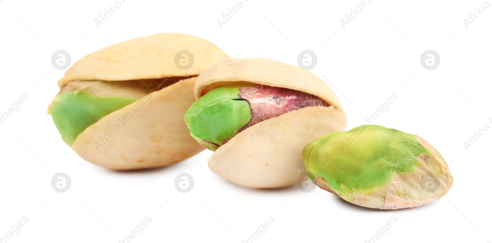 Photo of Three tasty pistachio nuts isolated on white