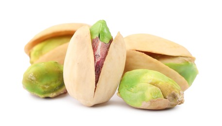 Photo of Many tasty pistachio nuts isolated on white