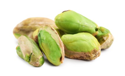 Photo of Tasty peeled pistachio nuts isolated on white