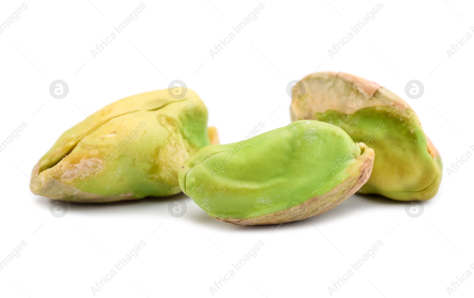 Photo of Tasty peeled pistachio nuts isolated on white