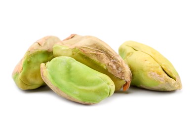 Tasty peeled pistachio nuts isolated on white