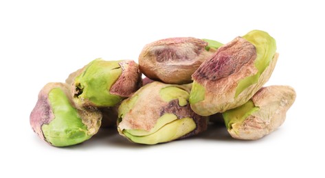 Tasty peeled pistachio nuts isolated on white