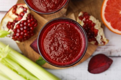 Photo of Fresh beetroot smoothie on white table, flat lay