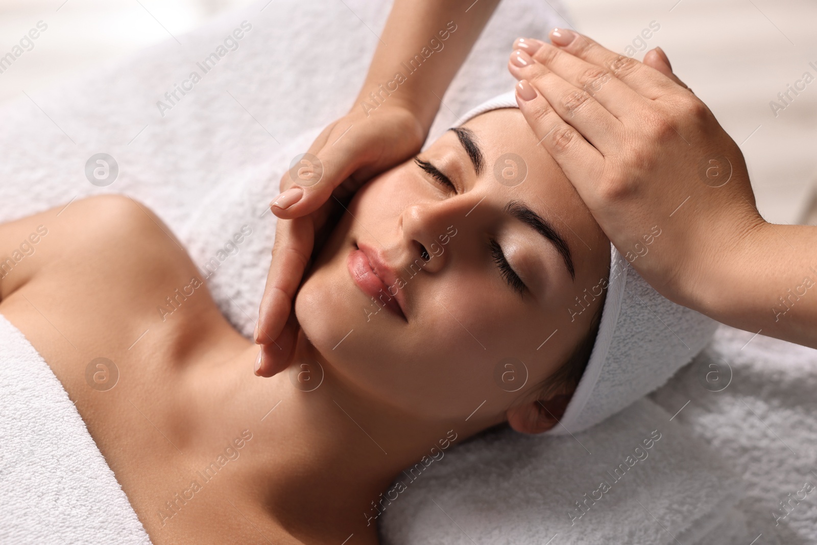 Photo of Attractive woman enjoying face massage, closeup. Beauty procedure