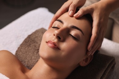 Photo of Attractive woman enjoying face massage, closeup. Beauty procedure