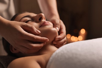 Photo of Attractive woman enjoying face massage, closeup. Beauty procedure