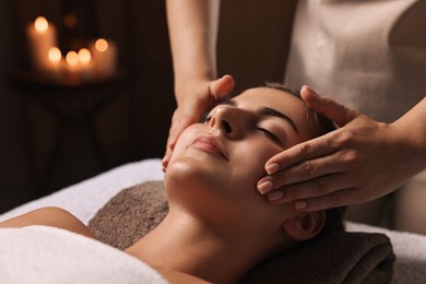 Photo of Attractive woman enjoying face massage, closeup. Beauty procedure