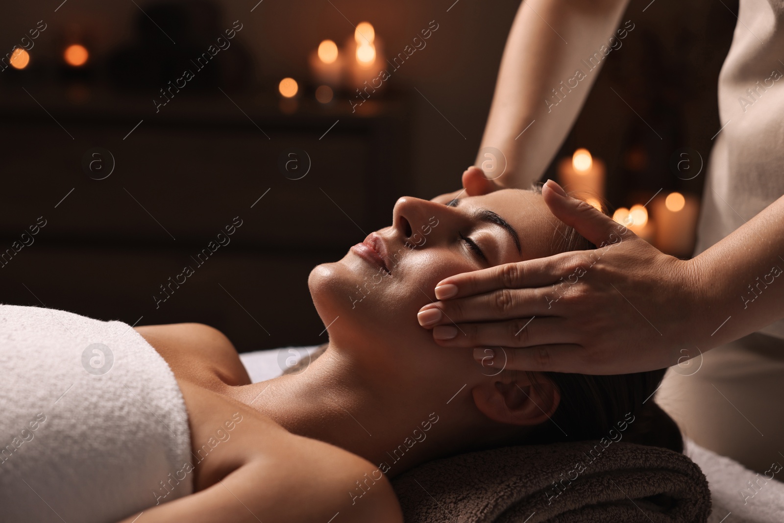 Photo of Attractive woman enjoying face massage, closeup. Beauty procedure