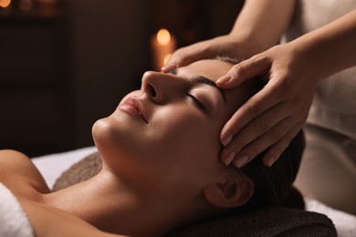 Photo of Attractive woman enjoying face massage, closeup. Beauty procedure