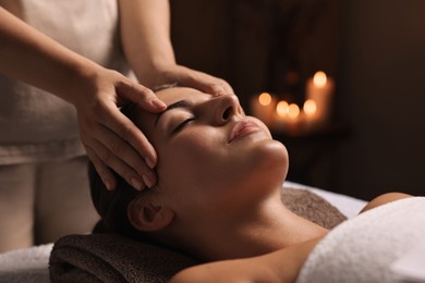 Photo of Attractive woman enjoying face massage, closeup. Beauty procedure