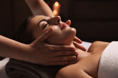 Photo of Attractive woman enjoying face massage, closeup. Beauty procedure