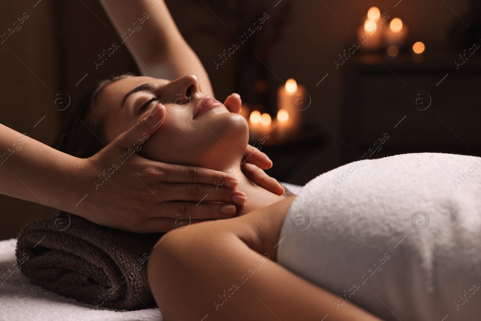 Photo of Attractive woman enjoying face massage, closeup. Beauty procedure