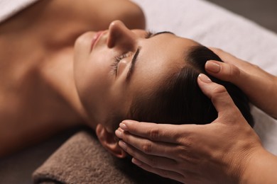 Photo of Attractive woman enjoying face massage, closeup. Beauty procedure