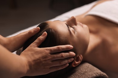 Photo of Attractive woman enjoying face massage, closeup. Beauty procedure