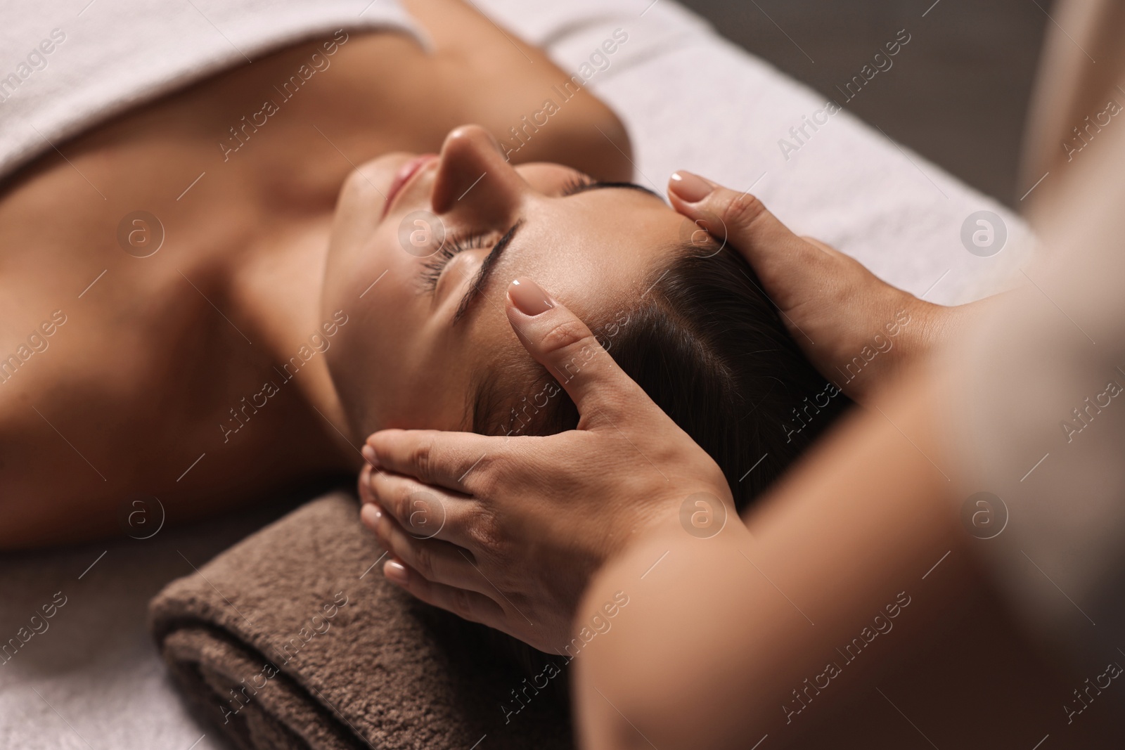 Photo of Attractive woman enjoying face massage, closeup. Beauty procedure