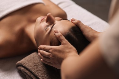 Photo of Attractive woman enjoying face massage, closeup. Beauty procedure