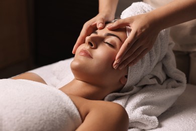 Photo of Attractive woman enjoying face massage, closeup. Beauty procedure