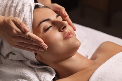 Photo of Attractive woman enjoying face massage, closeup. Beauty procedure