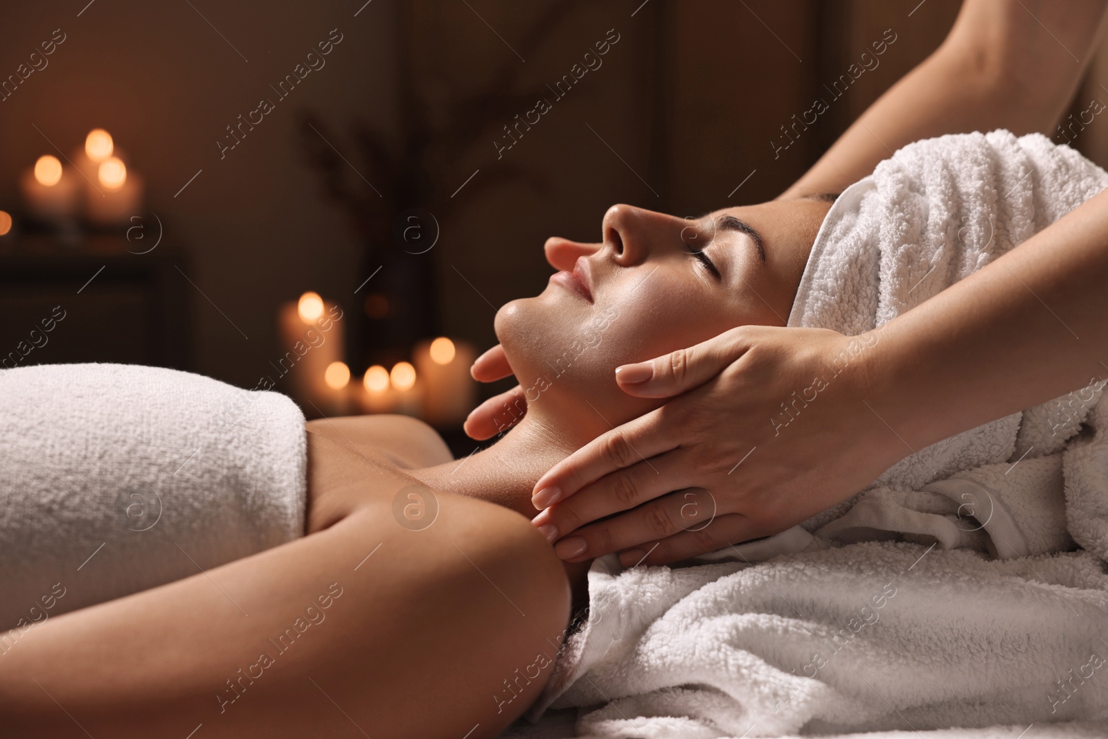 Photo of Attractive woman enjoying face massage, closeup. Beauty procedure